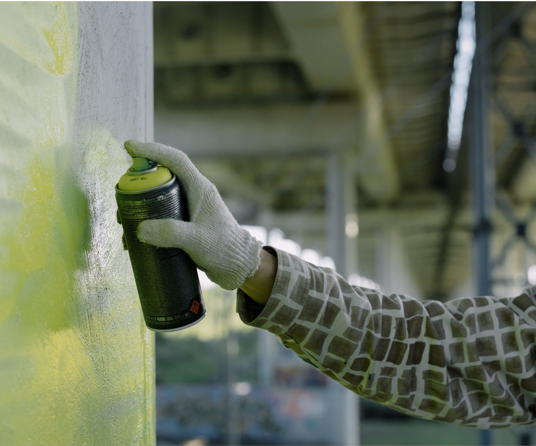 A person spraying paint full of VOCs and Formaldehyde