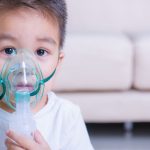 Can a Humidifier Help With Bronchitis? Tips for Maximizing Relief at Home little boy wearing a breathing machine mask for bronchitis relief