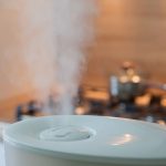 A picture of a humidifier with mist coming out the top