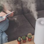 A woman reading near a humidifier not misting very good