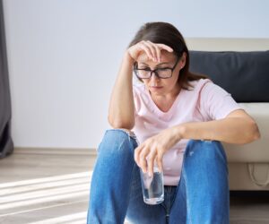 Frustrated woman waiting for CPAP repair after machine stopped working from using tap water instead of distilled