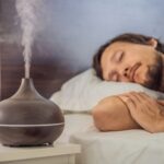 A man sleeping next to humidifier