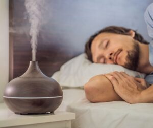 A man sleeping next to humidifier