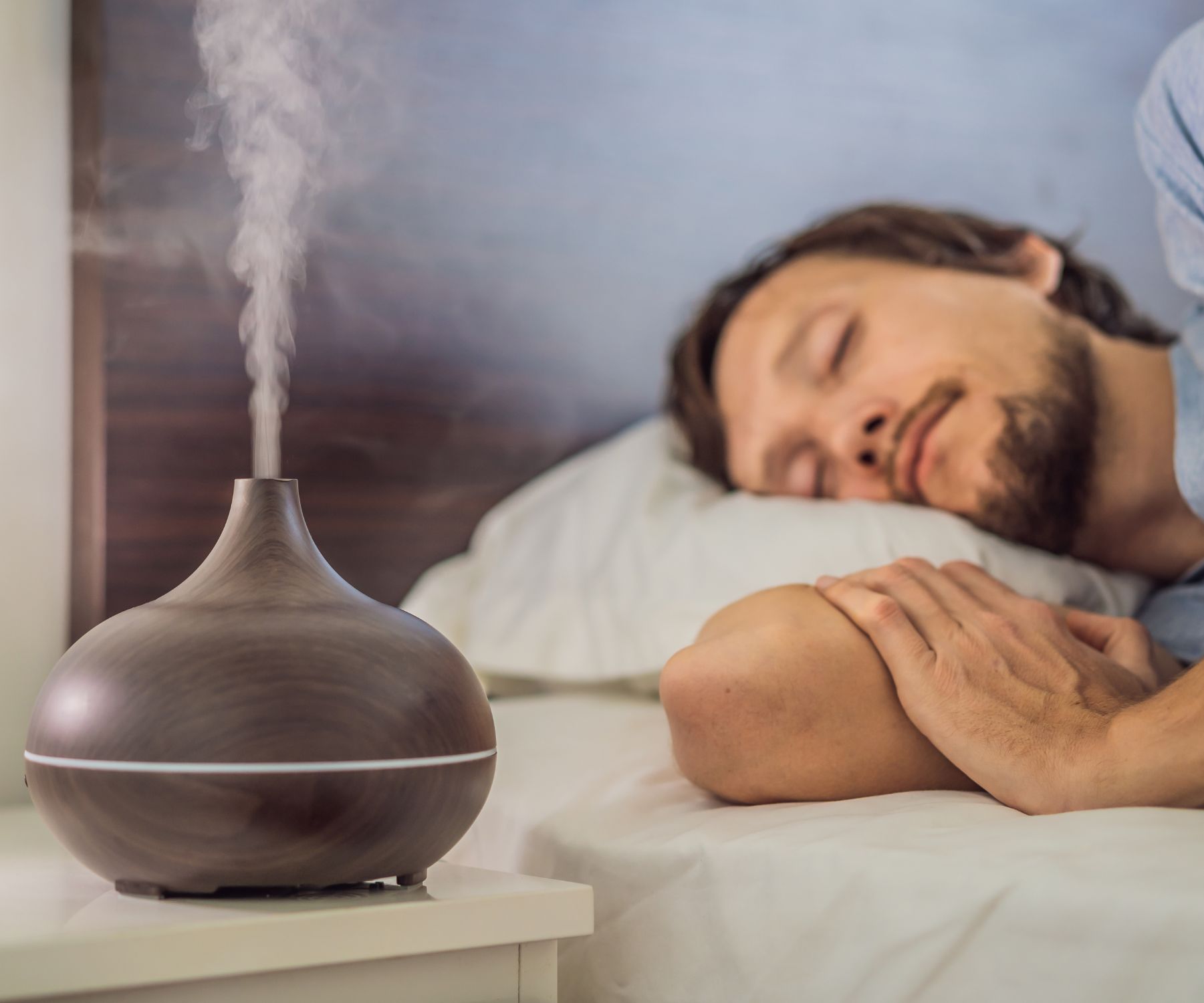 A man sleeping next to humidifier